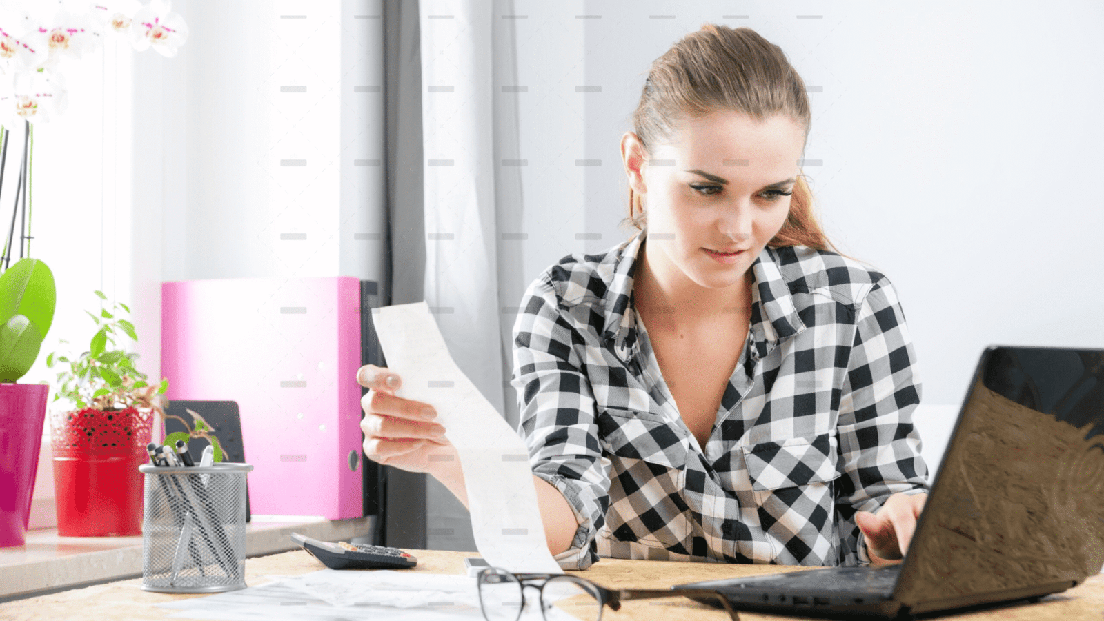 demo-attachment-3454-Smiling-young-woman-calculating-and-paying-bills-in-home-office-4-39051-original-protected-scaled